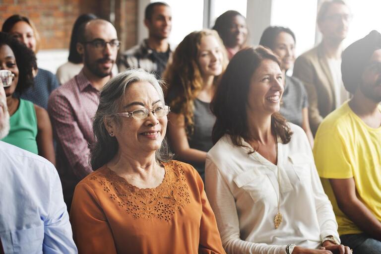 Group of diverse people listening to a presentation