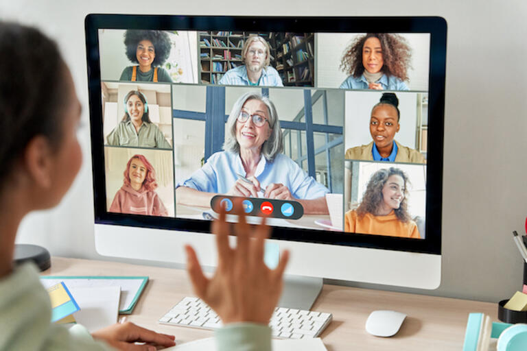 Student waving at virtual class with instructor 